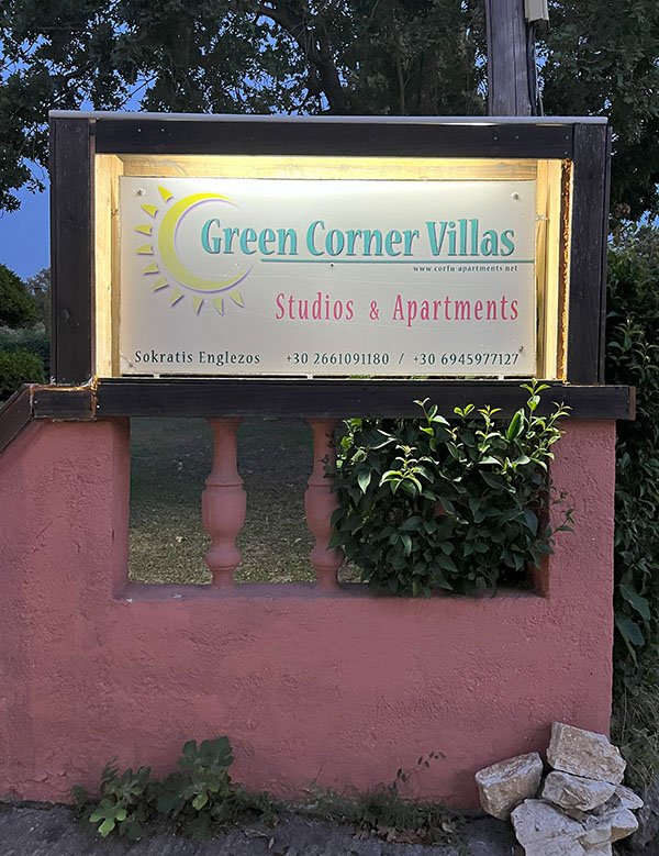 Green Corner Villas garden view with outdoor seating and BBQ